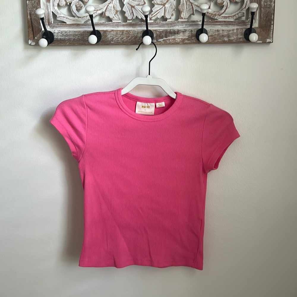 This is an anthropologie pink ribbed top with a modest neckline.